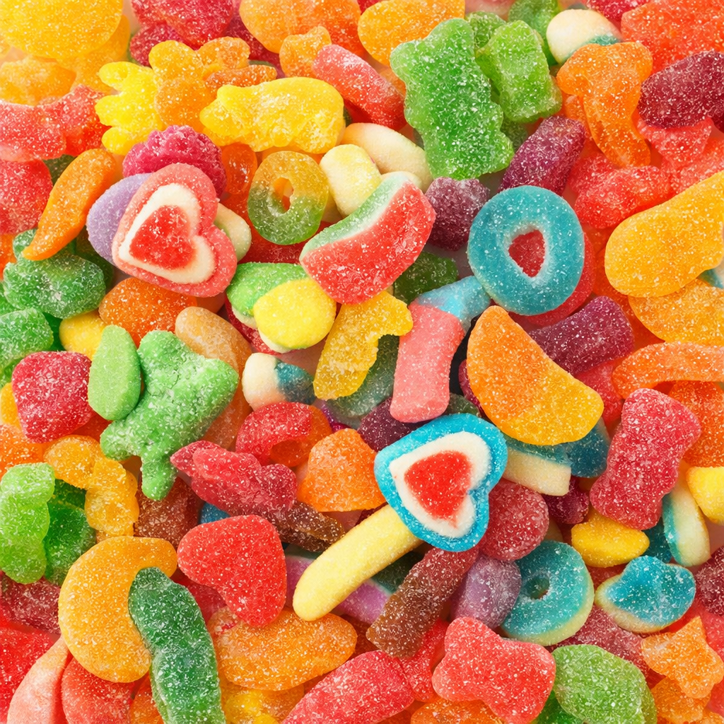 Assorted colorful gummy candies including hearts, stars, and other shapes.